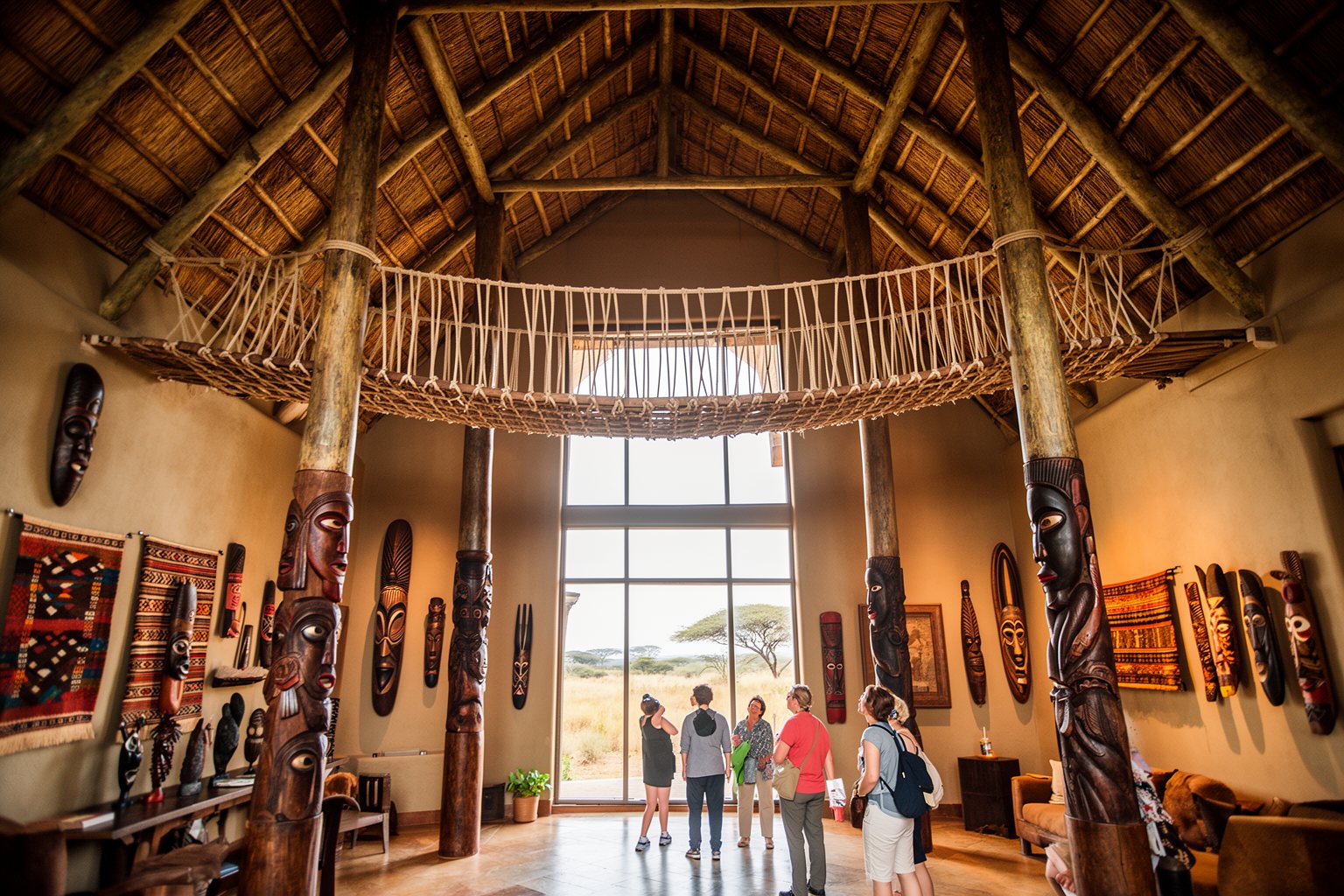 Discover the Magic: Top 10 Disney World Orlando Hotels You Must Visit! Soaring thatched lobby with carved pillars and a savanna window at Animal Kingdom Lodge