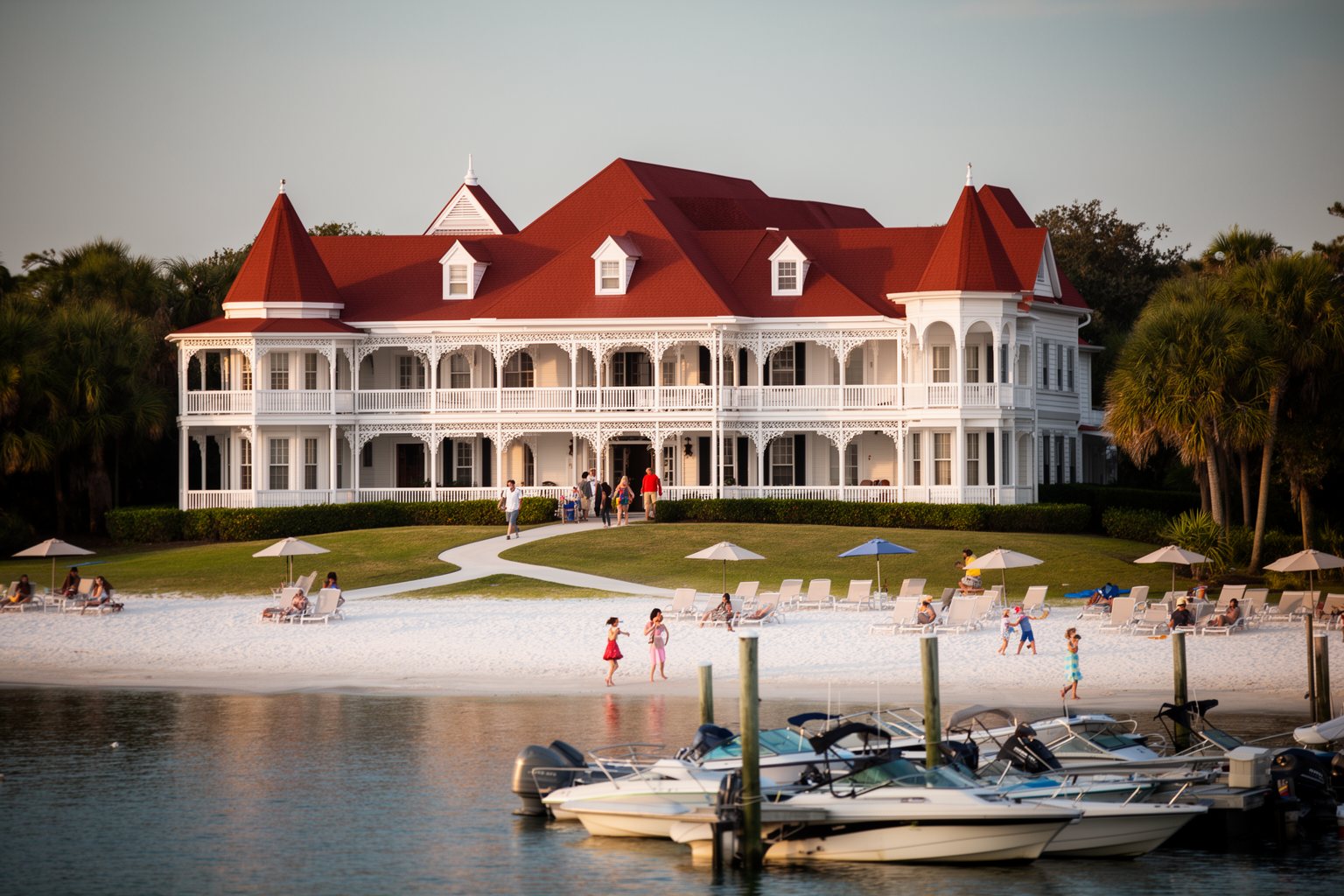 Discover the Magic: Top 10 Disney World Orlando Hotels You Must Visit! White Victorian buildings and red roofs of the Grand Floridian on the lagoon shore