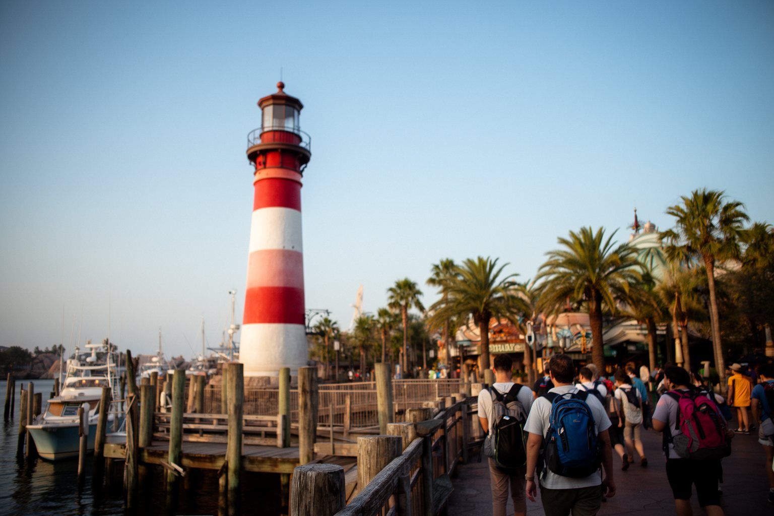 Striped lighthouse beside the harbour-style entrance plaza of Islands of Adventure
