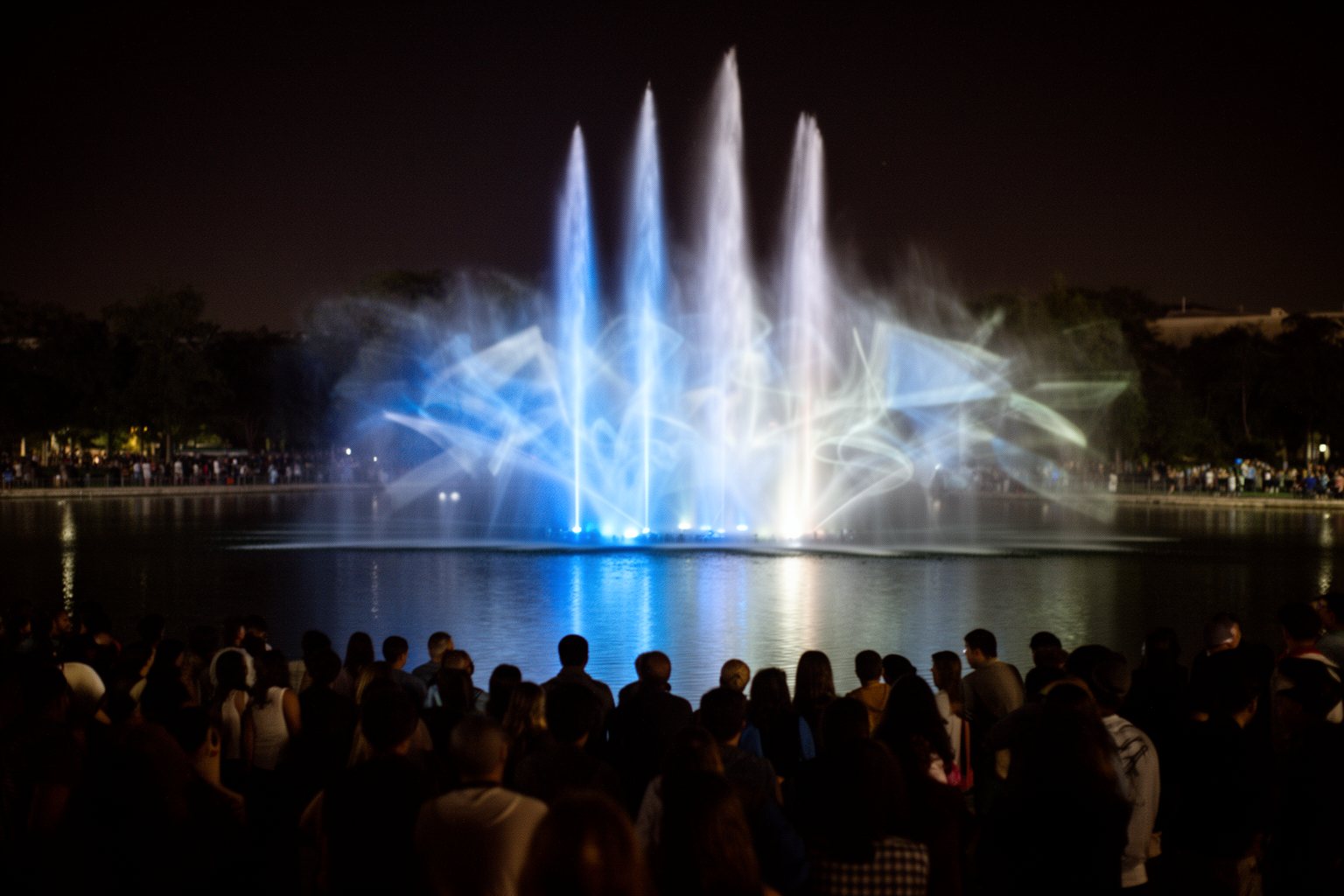 Universal Studios Orlando Nightlife: Rides, Shows and Eats Crowd watching a lit fountain and projection show on the lagoon at Universal Orlando