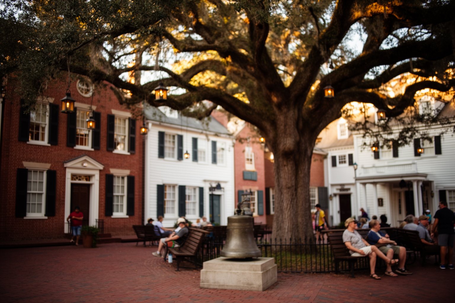 Magic Kingdom Hidden Gems: Secrets in Every Land Colonial-style buildings and a lantern-hung oak tree in Liberty Square