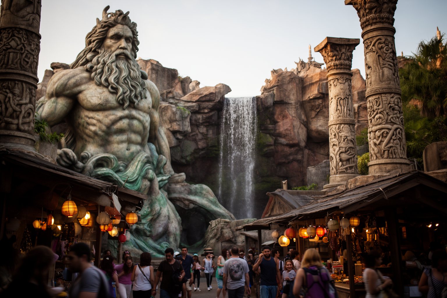 Weathered stone statue of a sea god and carved columns in The Lost Continent