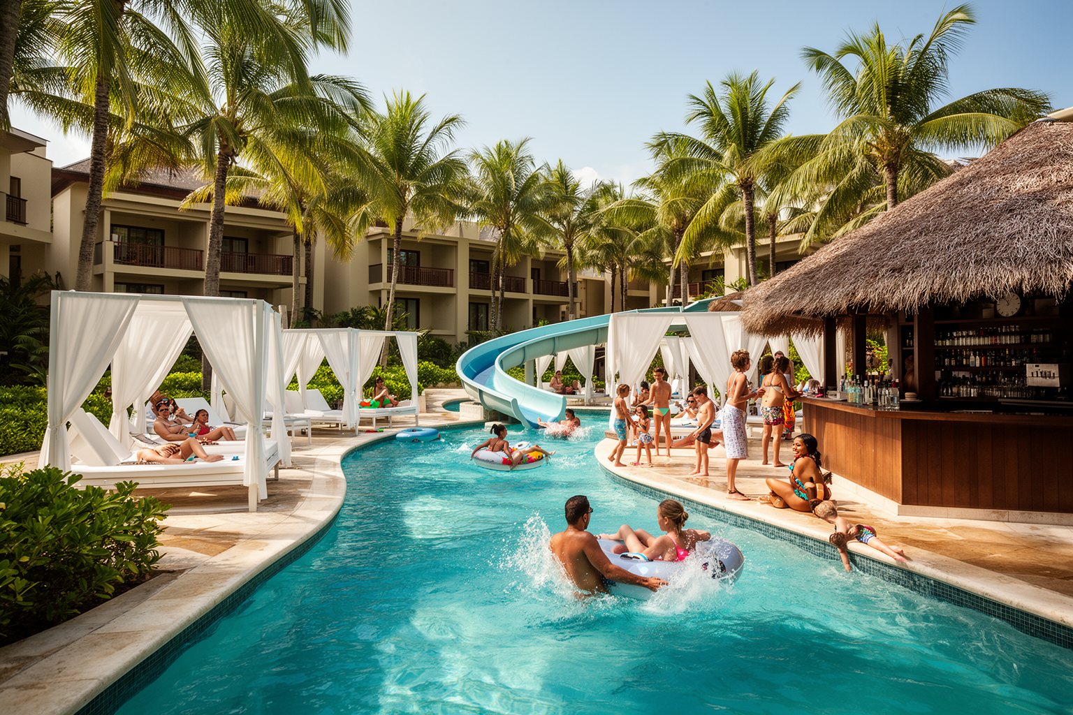 Resort pool with a lazy river and cabanas at Hilton Grand Vacations at SeaWorld