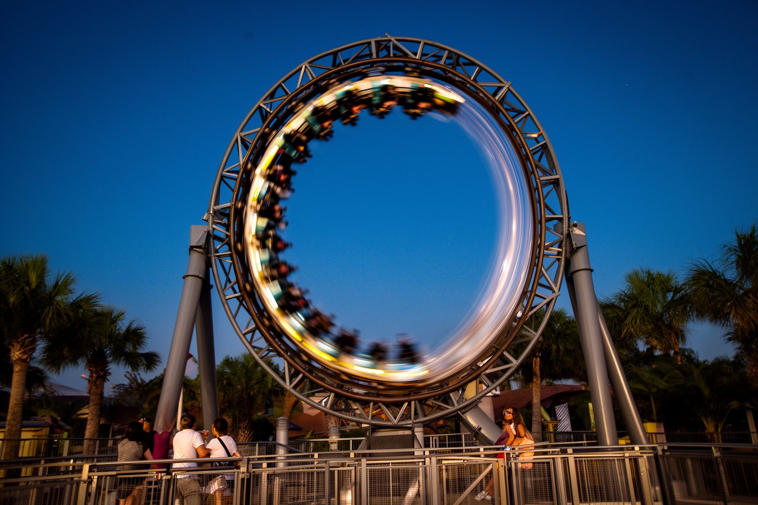 Universal Studios Orlando Nightlife: Rides, Shows and Eats Roller coaster racing through a lit loop at night at Universal Studios Orlando