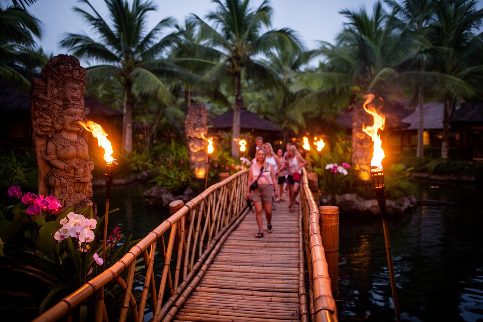 Universal Studios Florida Hotels: Hidden Gems Compared Bamboo bridge and flaming torches over the lagoon at Loews Royal Pacific Resort