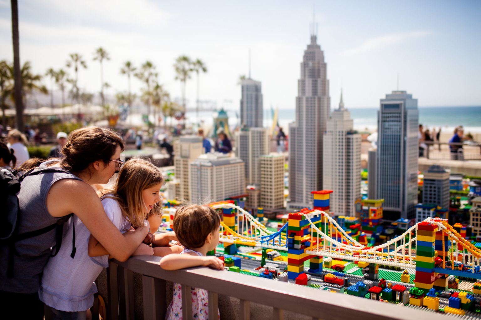 5 Best Family-Friendly Theme Parks Near Los Angeles Family admiring a miniature city built from colourful toy bricks at a theme park in Carlsbad