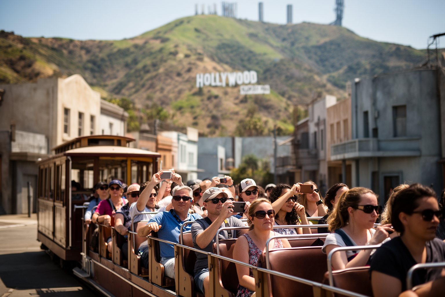 5 Best Family-Friendly Theme Parks Near Los Angeles Tourists on a studio backlot tram tour passing movie-set facades in Hollywood