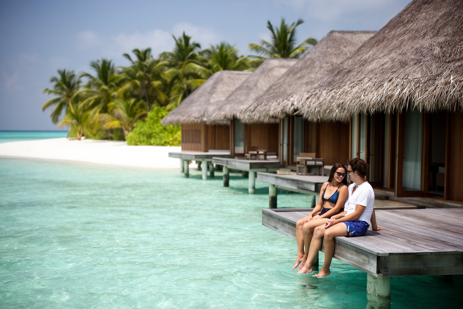 Overwater villas on stilts above a turquoise lagoon in the Maldives