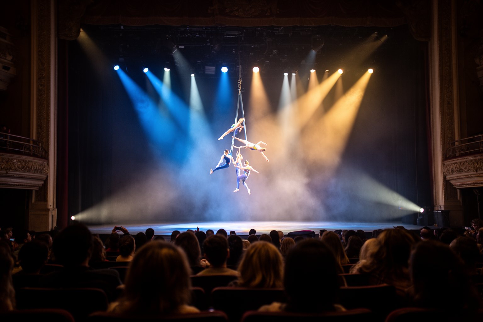 Vegas Nightlife Guide: Clubs, Shows, Casinos and Late Eats Audience silhouetted watching acrobats perform on a lit stage at a Las Vegas show