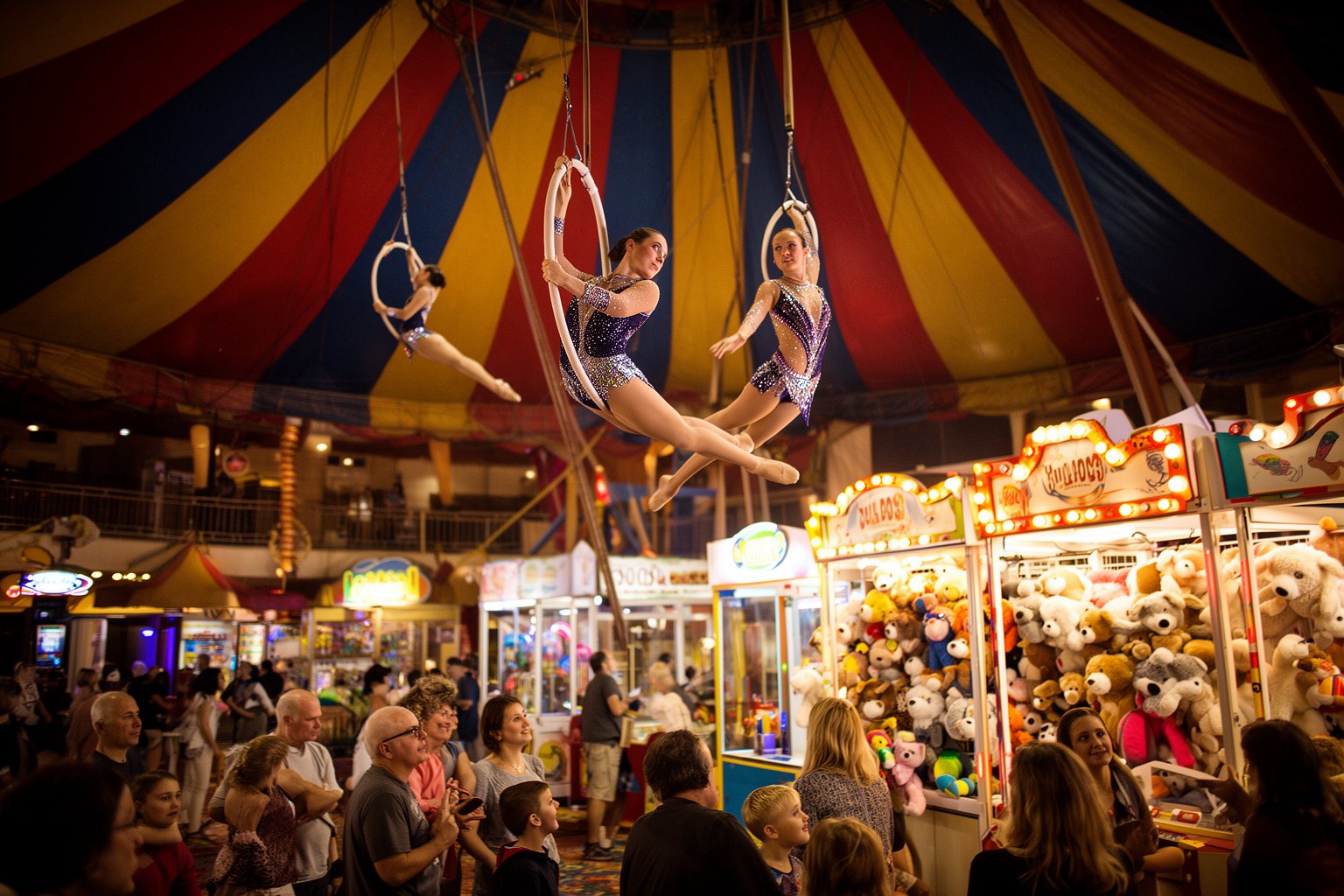Your Family’s Perfect Home Base: Child-Friendly Hotels in Vegas Acrobats performing on a trapeze above a carnival games midway at Circus Circus Las Vegas