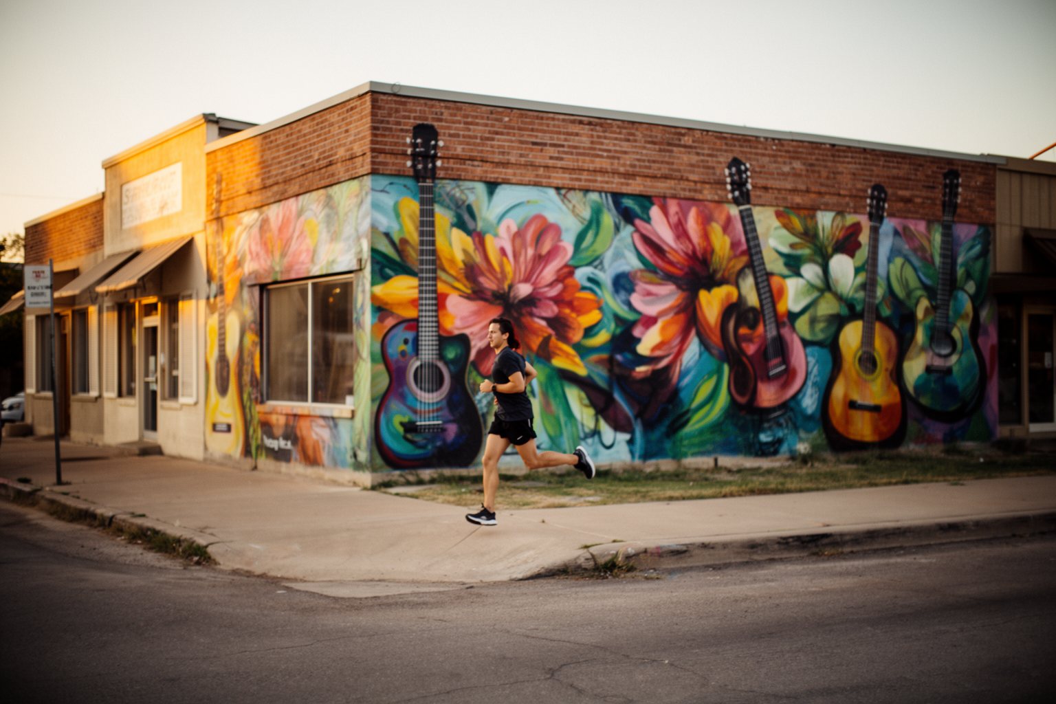 Jogging in Austin: Best Routes for Runners Runner passing colourful murals on a historic East Austin street along a music-history route