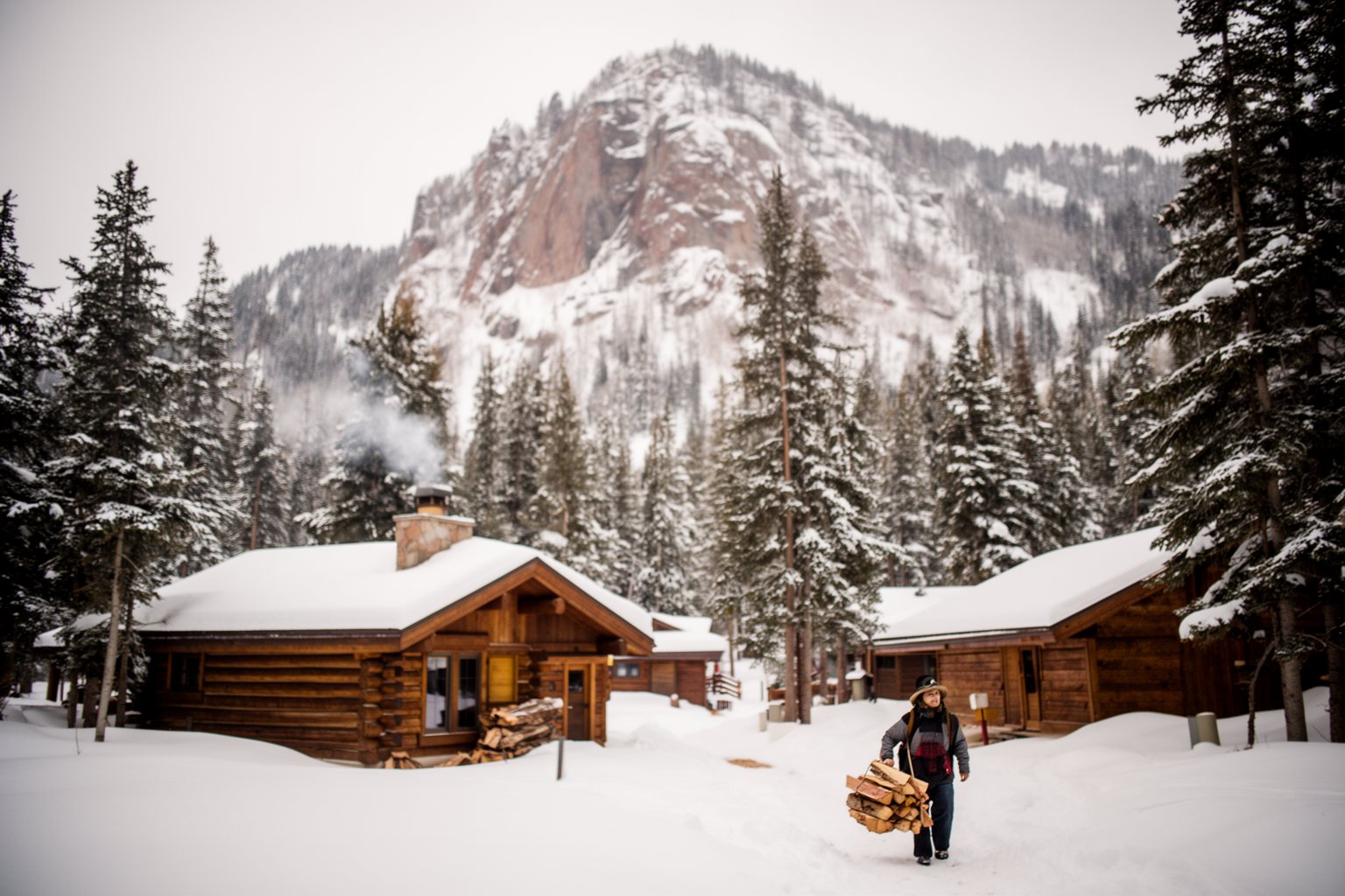 Utah Ski Towns: Park City, Alta, Snowbird and More Rustic wooden cabins among snowy pines at the foot of a mountain at Sundance, Utah