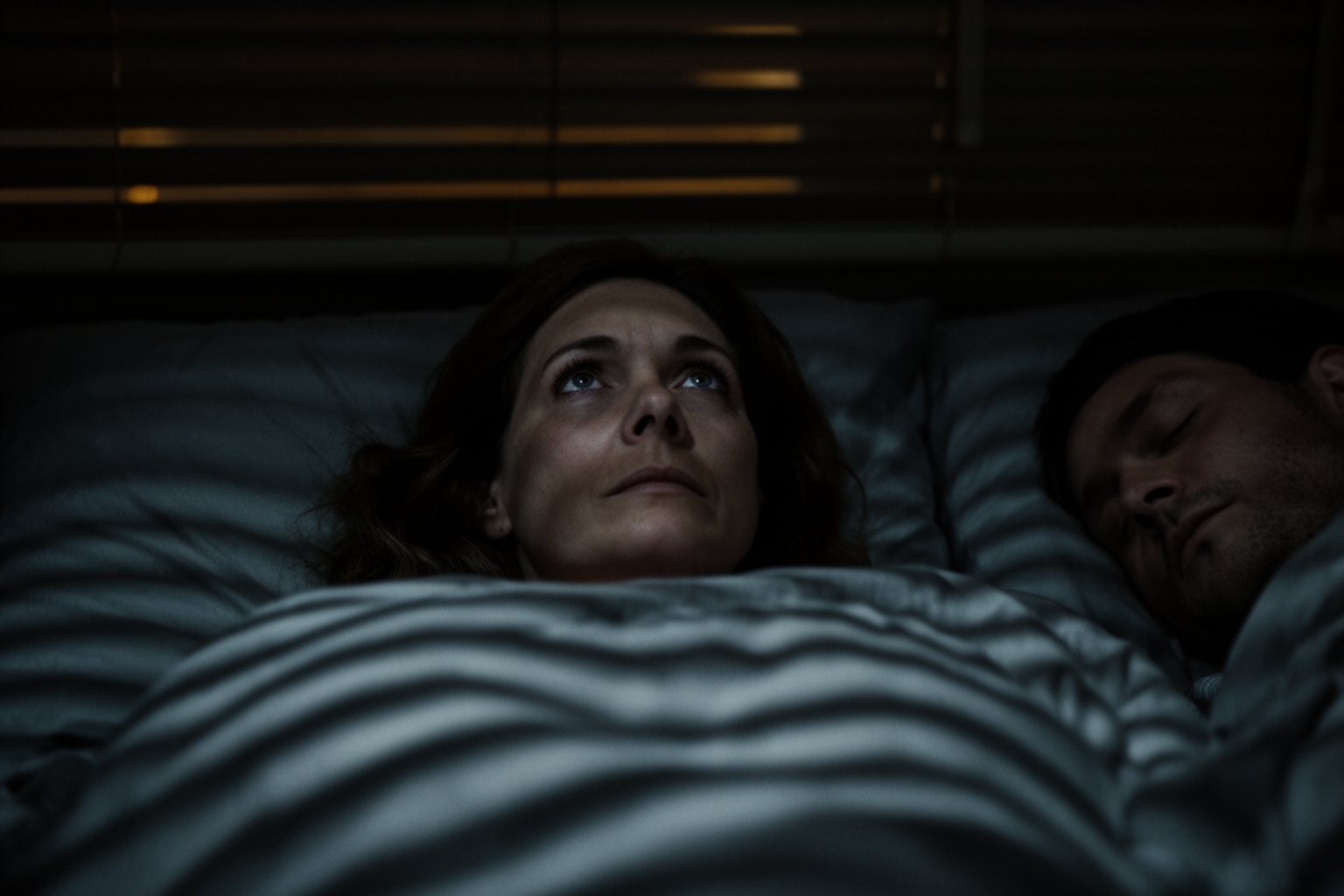 Hacking Your Sleep For A Restful Night Woman lying awake in bed in the middle of the night, a sign of a sleep disorder