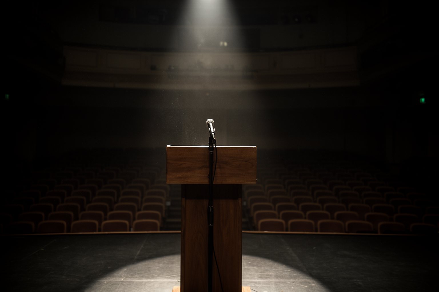 Star-Politicos: Is Mixing Celebrities and Politics a Ticking Time Bomb? Empty podium under a single spotlight in a dark auditorium, a reflection on celebrity politics
