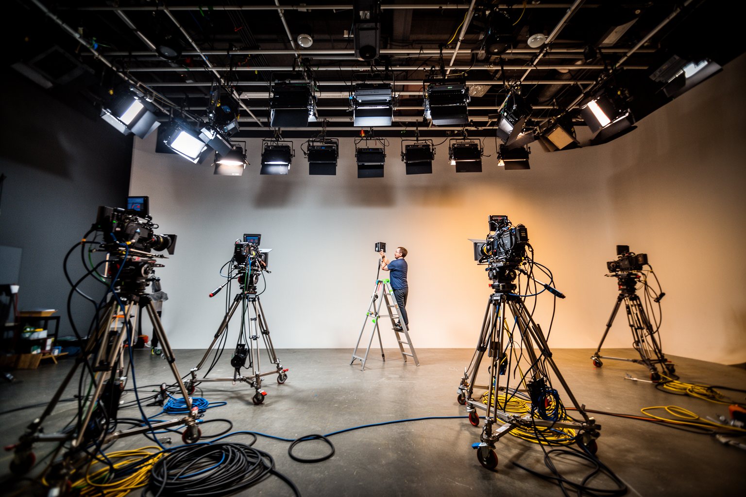 Entertainment Industry Behind the Scenes: Hidden Faces Empty television studio set under a lighting rig before filming, behind the scenes of the industry
