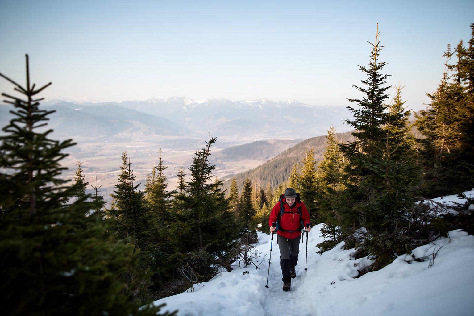 The Ultimate Guide to Spending Holidays Alone Solo hiker on a snowy mountain trail during a holiday adventure alone