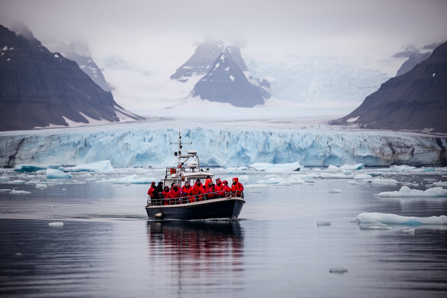 10 Secret Destinations Only Travel Pros Know Small expedition boat in an Arctic fjord below snowy mountains and a glacier in Svalbard, Norway